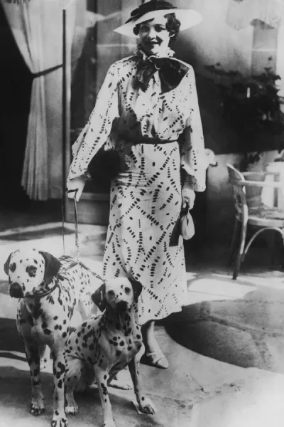 Woman with two dalmatians wearing patterned dress (B&W)