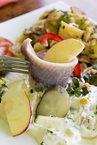 Young salted herring with yoghurt dressing, fruit and potatoes