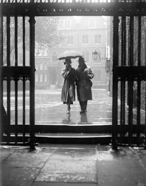 Prints of A couple walking in the rain under an umbrella in Deans Yard Westminster Abbey