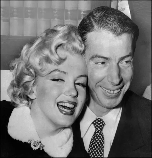 Marilyn Monroe with Joe DiMaggio during their wedding ceremony