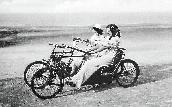 Beach car to ride in the sand led by two women. photography around 1910