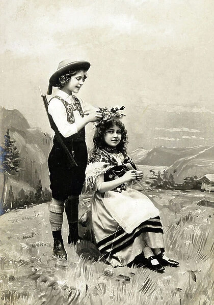Couple of children posing in the mountains in Alpine costume (Bavarian)