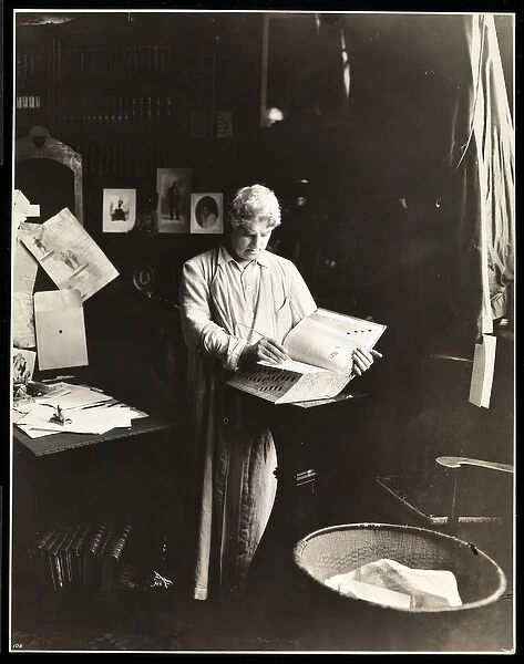 David Belasco standing holding a dictionary, after 1909 (silver gelatin print)