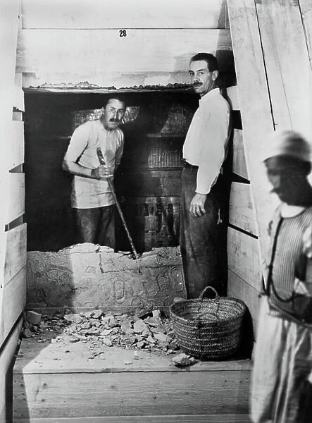 English archeologist Howard Carter and Arthur Mace at the entrance of Toutankhamon's grave in the Kings valley in Thebes in Egypt (door of the interior room of the grave), 1923