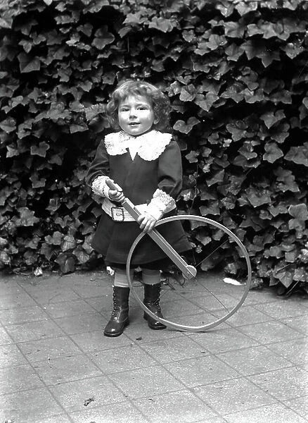 France: external portrait of a little girl with her toy, 1900