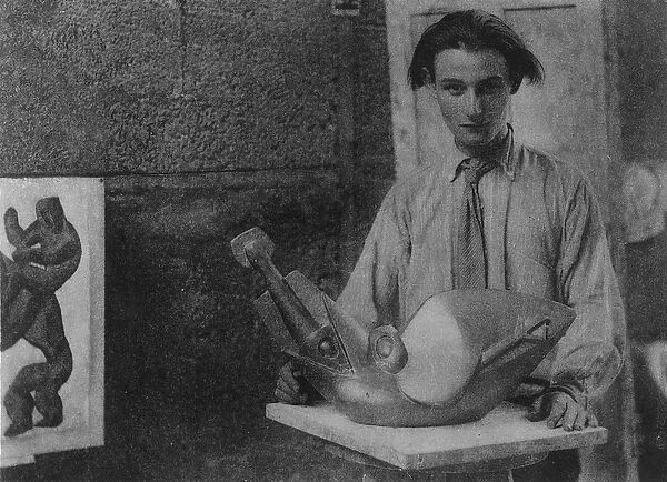 Henri Gaudier-Brzeska with his sculpture Bird Swallowing Fish in Kettles Yard