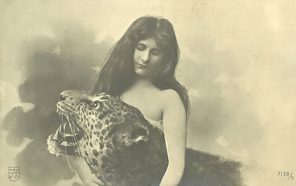 Long-haired girl with arms around stuffed leopard (b  /  w photo)