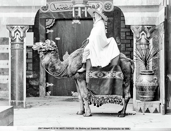 A man dressed as a Bedouin on the back of a camel, during the Carnival festivities held in Florence in 1886