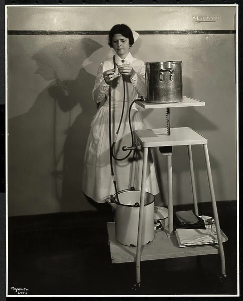 A nurse demonstrating a special apparatus with tubes and supply