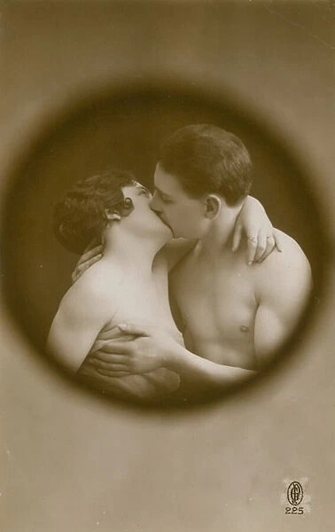 Postcard of a young man and woman kissing as viewed through a peephole, sent in 1913 (b  /  w photo)