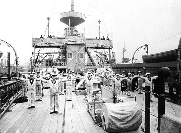 Ratings taking part in Physical Training exercises on the upper deck of an unidentified