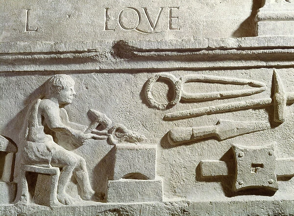 Relief depicting a blacksmiths shop and tools (stone)