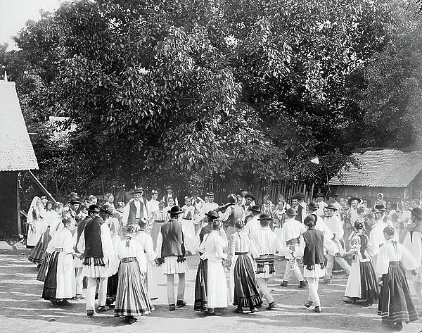 Romania, Walachia, JU, Ploiesti: Romanians in traditional dress dance in the village square, 1900