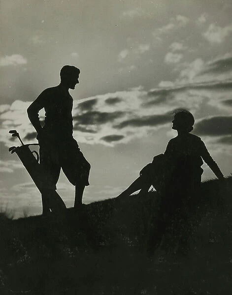 Silhouette of man and woman playing Golf, 1930-40 (b / w photo)