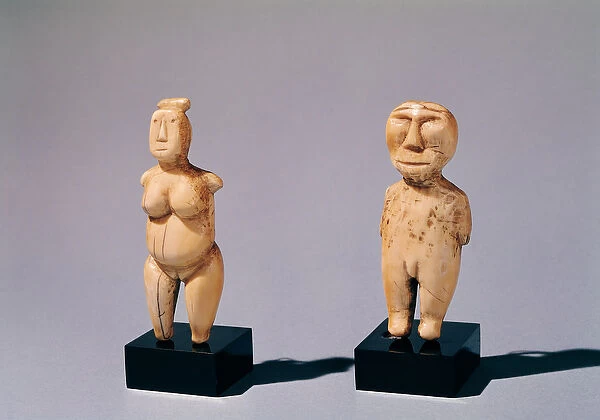 Two statuettes of a man and a woman, from the Bering Strait (ivory)