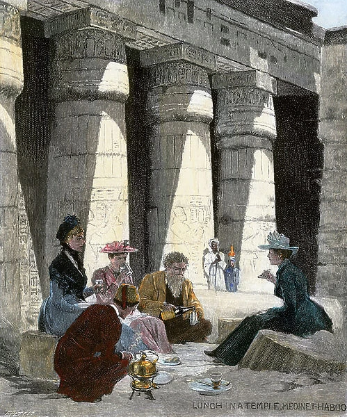 Tourists taking their lunch in the ruins of the Egyptian temple of Medinet, a man wearing a fez takes care of the accommodation of the picnic and in the background, their guide remains discreet by a woman wearing a jug on her head, around 1870