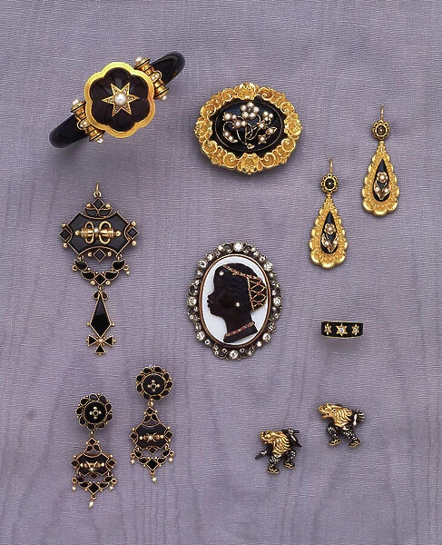 A Victorian jewelled and gold-mounted black enamel memorial bangle; A Victorian gemset, gold and enamel demi-parure; An attractive cameo habille pendant; A gold mounted black glass and seed-pearl demi-parure; And a pair of Japanese cufflinks (gold)