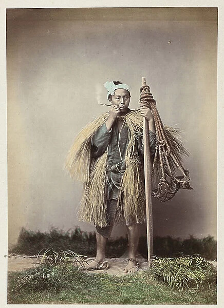 Warrior in winter dress, smoking the pipe - Coolie winter dress - Japan 1880-1910 - Hand coloured photo