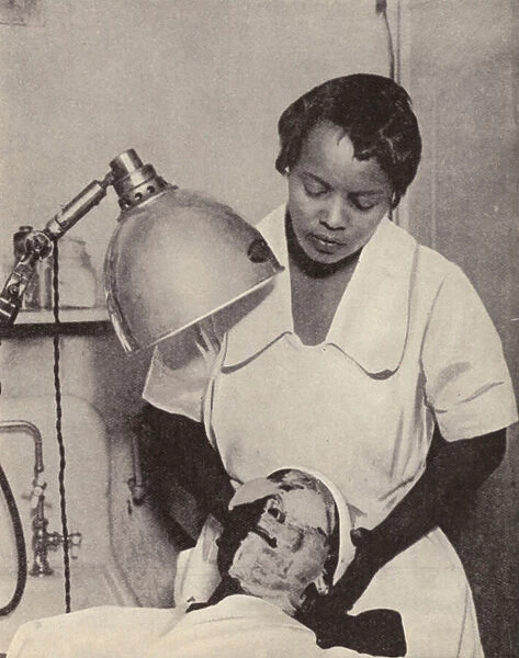 Women having a skin whitening facial treatment at a beauty parlour in Harlem, New York (b  /  w photo)