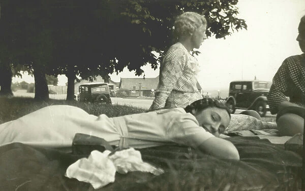 Women sunbathing on the grass (b / w photo)