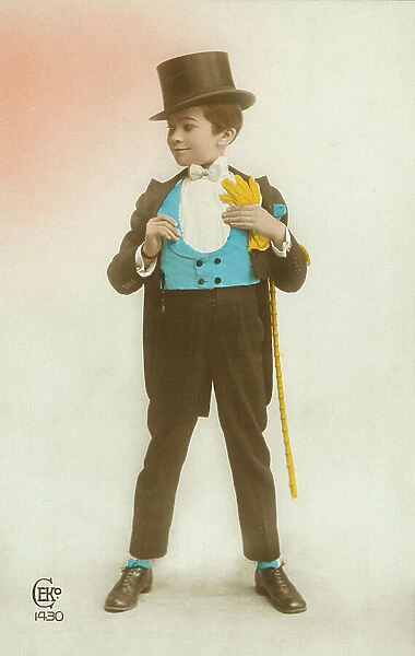 Young boy wearing a suit with bright blue waistcoat and yellow gloves (coloured photo)