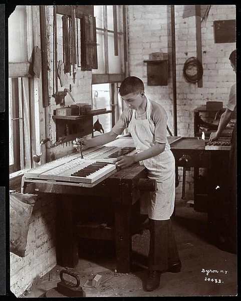 A young man working in the Harrington Piano Co. factory, 1907 (silver gelatin print)