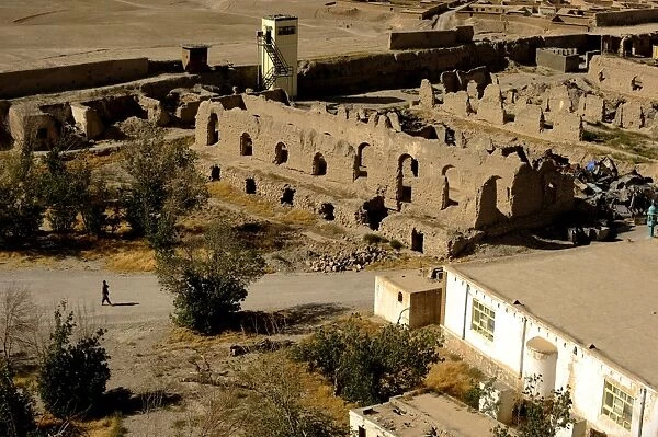 An Afghan National Army soldier walks near historic ruins within Alexander the Great s