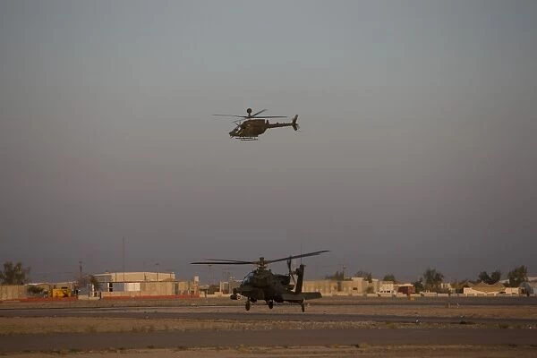 An AH-64D Apache Longbow Block III waits for an OH-58 Kiowa to clear his flight space