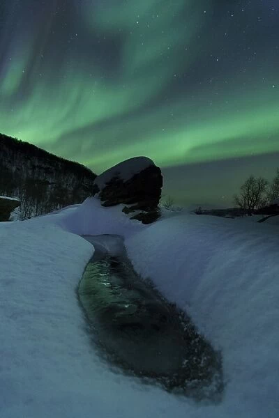 Aurora Borealis over a frozen river, Norway