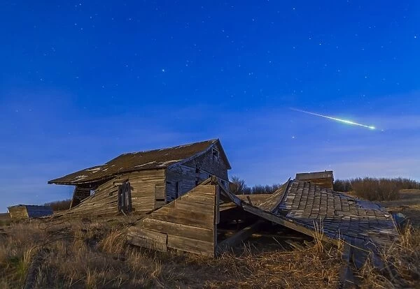 A bright bolide meteor breaking up as it enters the atmosphere