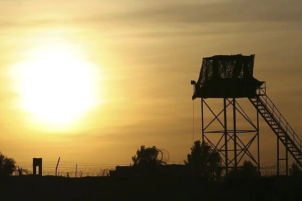 Camp Warhorse guard tower at sunset