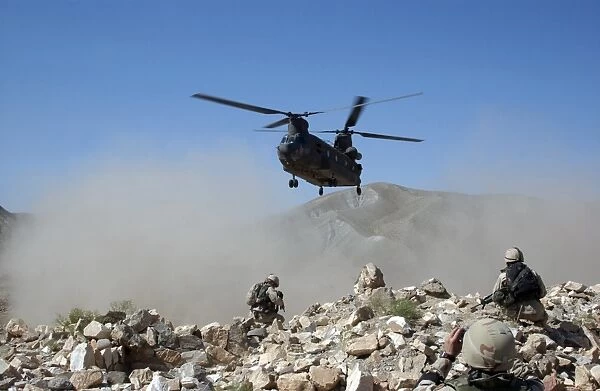 Clouds of dust kicked up by the rotor wash of a CH-47 Chinook helicopter in Afghanistan