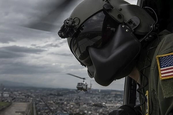 Crew chief scans the area from a UH-1N Huey helicopter