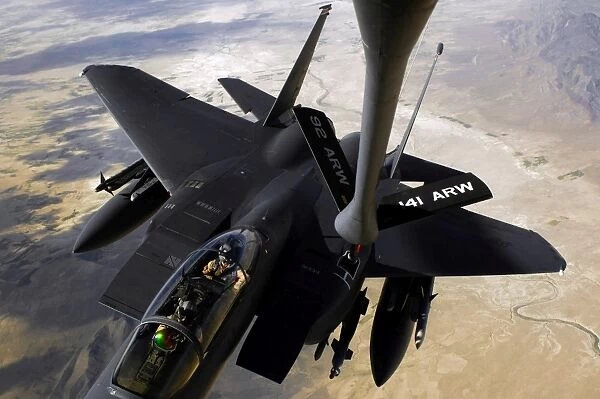 An F-15E Strike Eagle aircraft receives fuel from a KC-135R Stratotanker