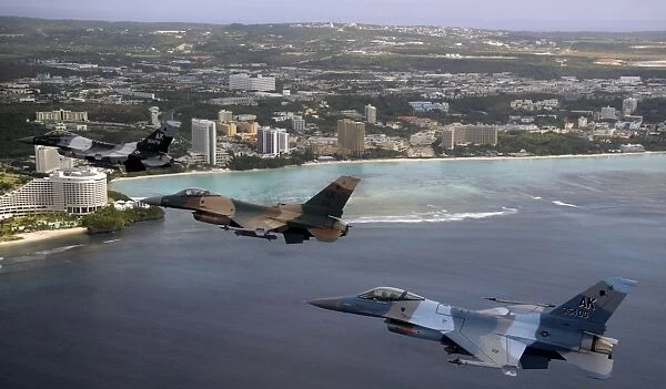 Three F-16 Fighting Falcons fly in formation over Tumon Bay, Guam