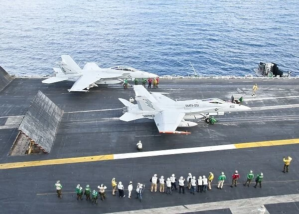 F  /  A-18 aircraft prepare to take off from the flight deck of USS Enterprise