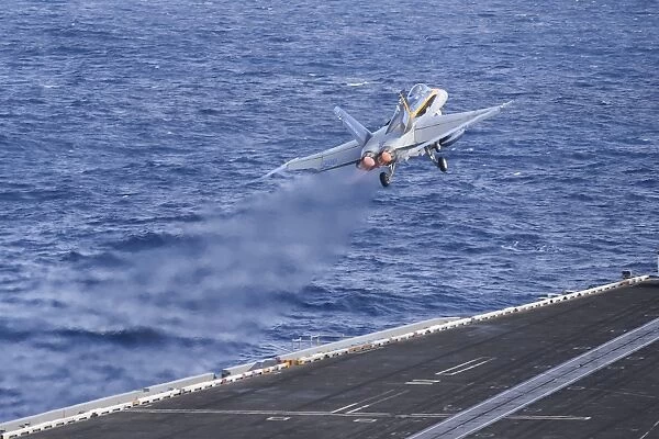 An F  /  A-18C Hornet launches from USS Nimitz