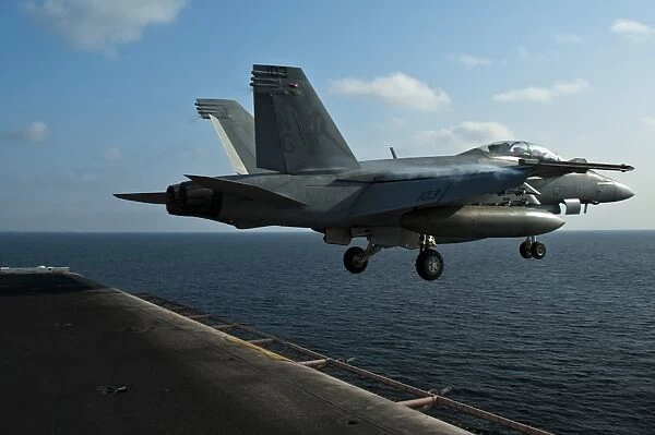 An F  /  A-18F Super Hornet launches from USS John C. Stennis