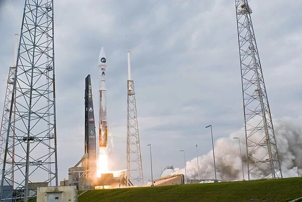 Fire and smoke signal the liftoff of the Atlas V  /  Centaur launch vehicle