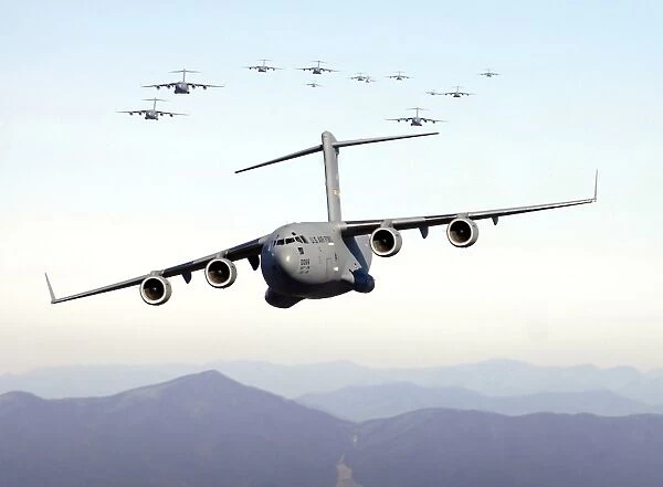 A formation of 17 C-17 Globemaster IIIs fly over the Blue Ridge Mountains