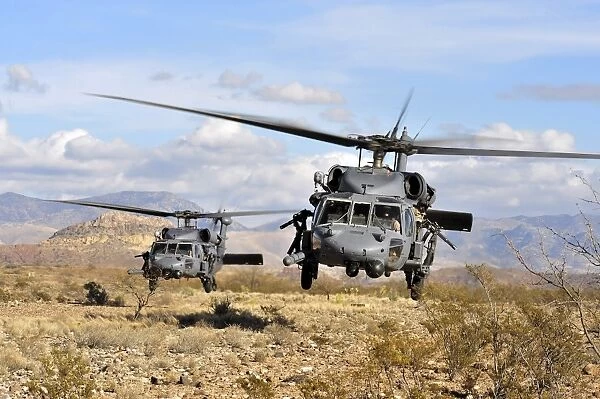 Two HH-60 Pavehawk helicopters preparing to land