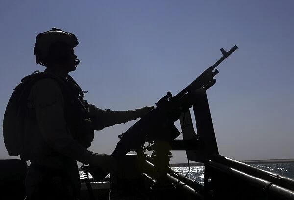 Information Systems Technician manning an M240 machine gun at Lake Quadsiyah near Haditha