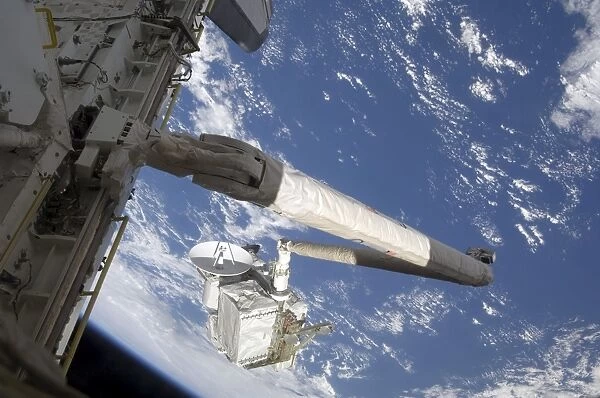 The Integrated Cargo Carrier in the grasp of the shuttles remote manipulator system arm