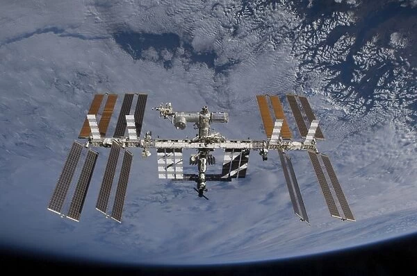 International Space Station set against the background of a cloud covered Earth