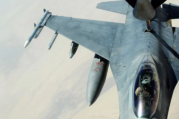A KC-135 Stratotanker refueling an F-16CJ Fighting Falcon over Iraq