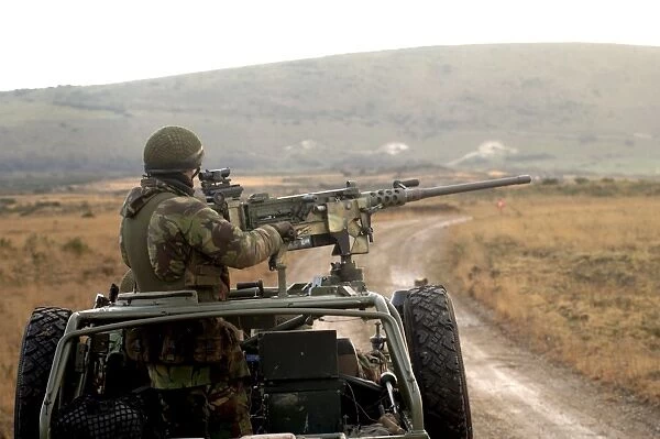 A member of the Pathfinder Platoon fires a heavy machine gun atop a Land Rover