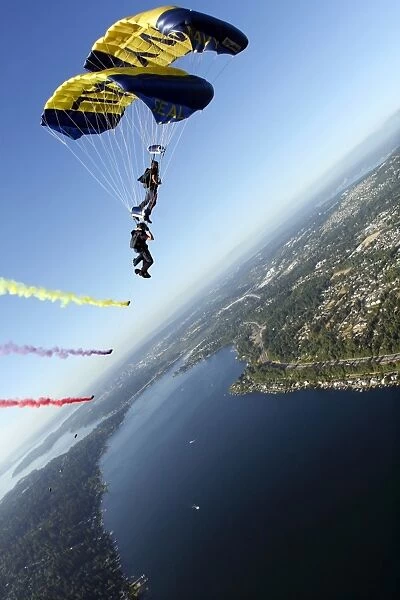 Members of the U. S. Navy Parachute Team, the Leap Frogs, perform a bi-plane with