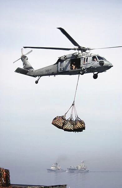 An MH-60S Knighthawk delivering cargo