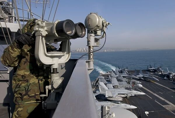 Operations Specialist Seaman stands as lookout watch on USS Carl Vinson