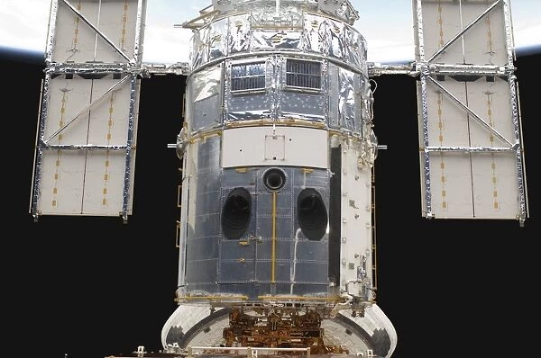 A portion of the Hubble Space Telescope locked down in the cargo bay of Space Shuttle